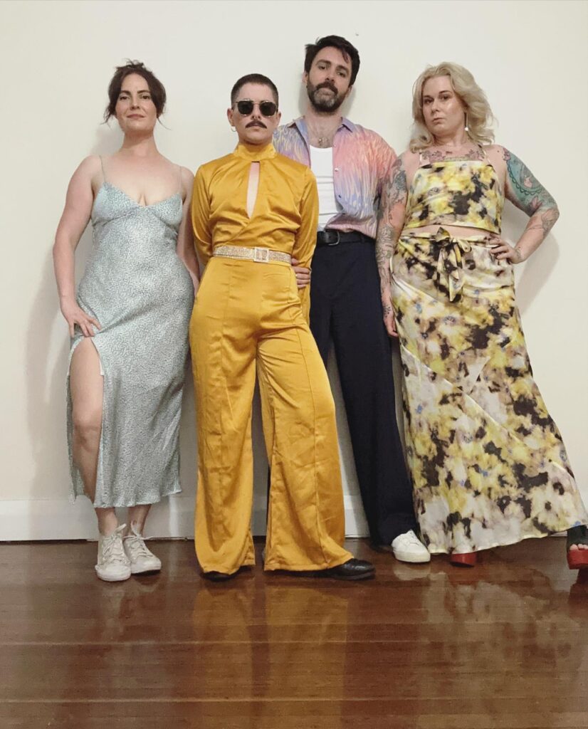 Jojo, Tim, Will, and Vee, in cool outfits.