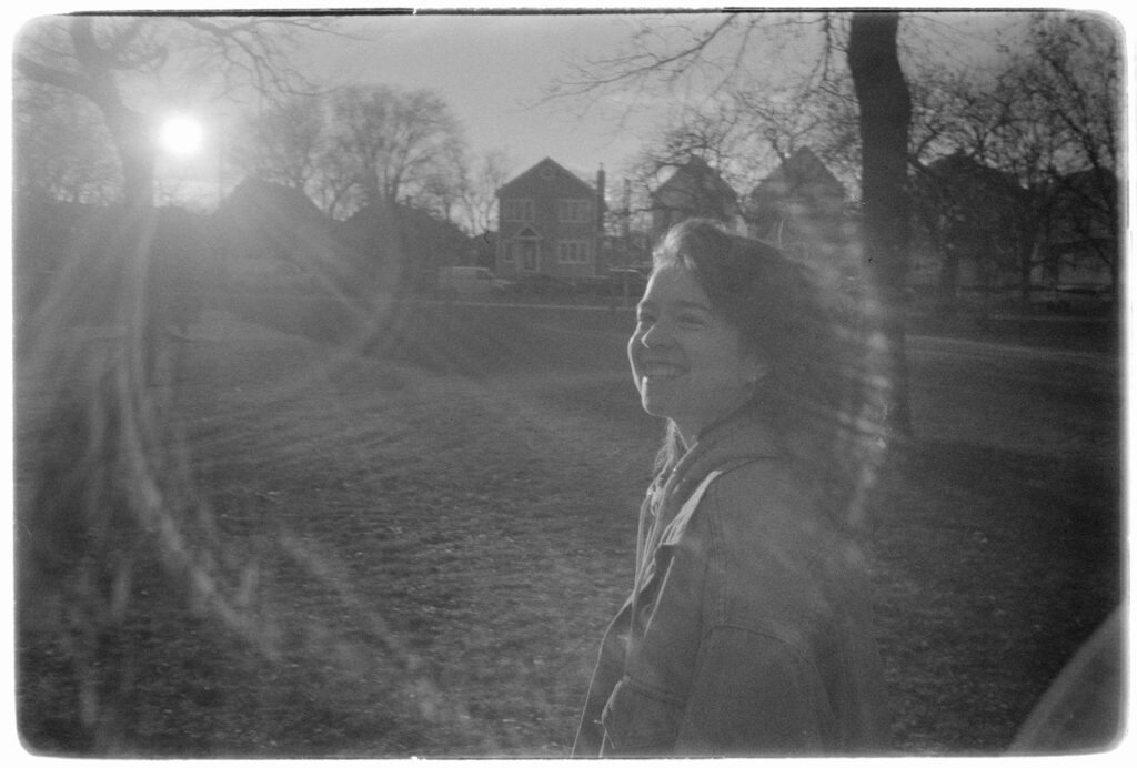 My partner Hannah in monochrome, obscured by a lens flare.