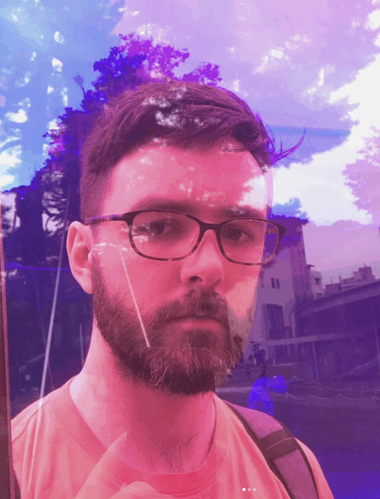 A double-exposure photo of Will, in glasses and bisexual colors.
