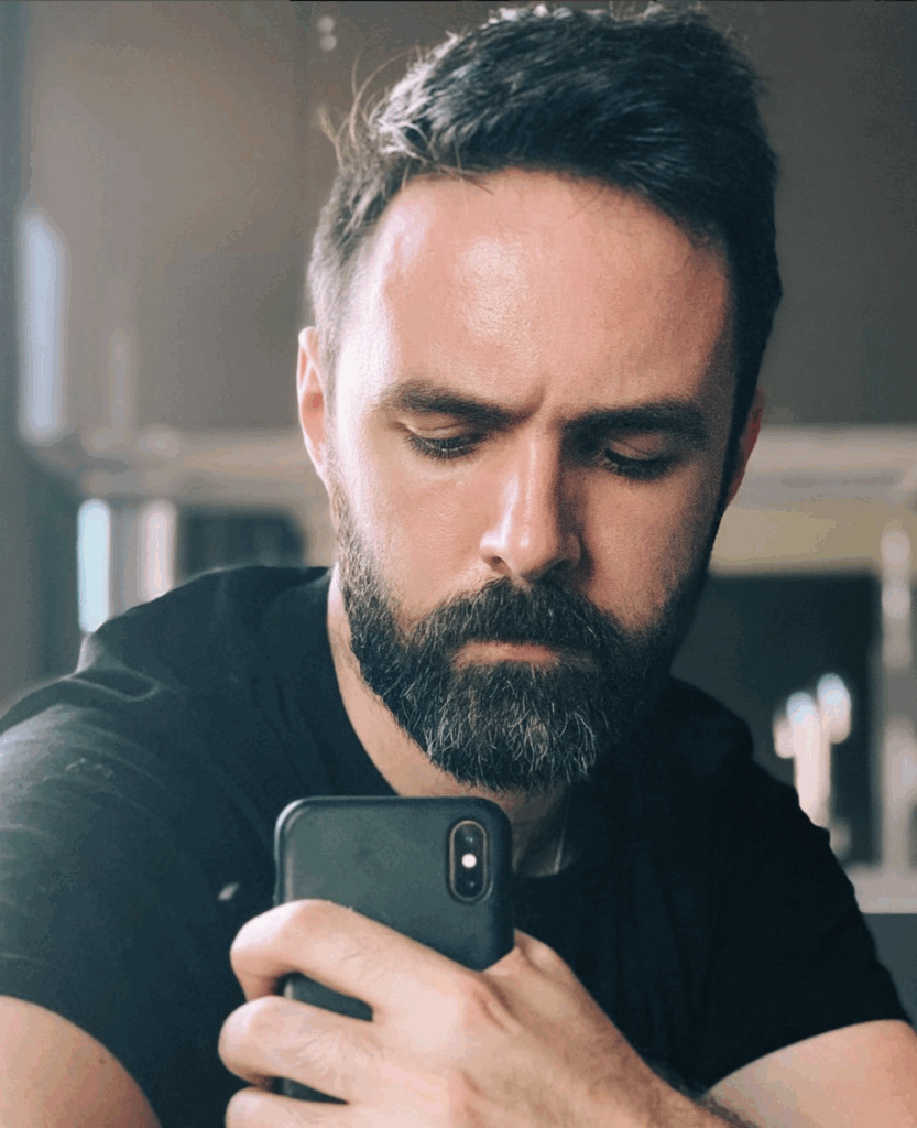 Will frowning and gripping a phone with ferocity.